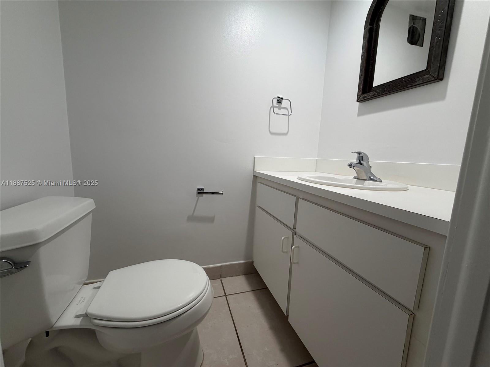 8101 Southwest 72nd Avenue, Unit 219W Miami, FL 33143 - Photo 19 of 30 a bathroom with a toilet sink and mirror