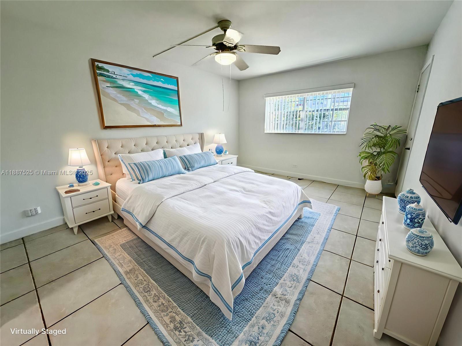 8101 Southwest 72nd Avenue, Unit 219W Miami, FL 33143 - Photo 20 of 30 a bedroom with bed and a flat screen tv