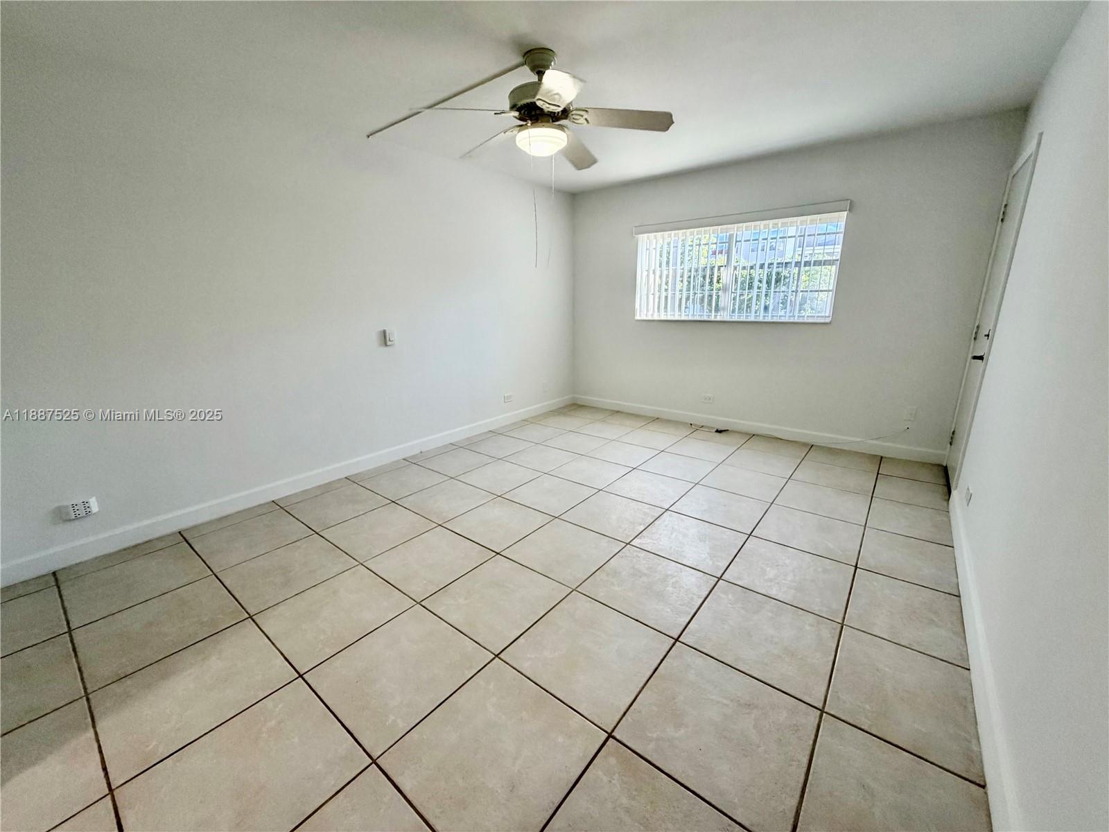 8101 Southwest 72nd Avenue, Unit 219W Miami, FL 33143 - Photo 21 of 30 a view of an empty room and a chandelier fan