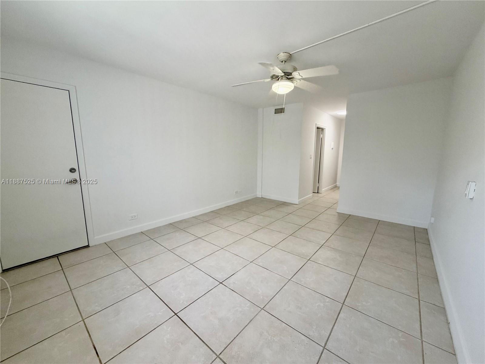 8101 Southwest 72nd Avenue, Unit 219W Miami, FL 33143 - Photo 22 of 30 an empty room with white walls and fan