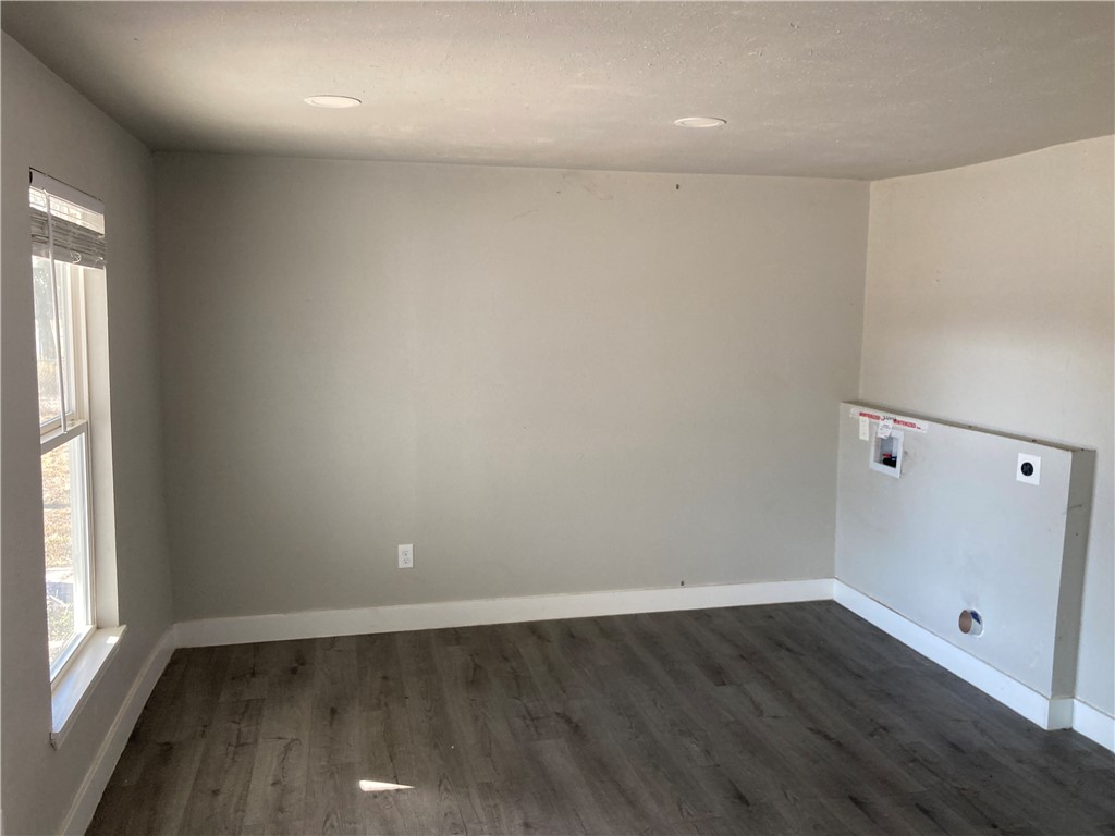 600 West St Marys Street Mathis, TX 78368 - Photo 5 of 11 an empty room with wooden floor and windows
