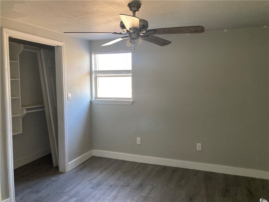 600 West St Marys Street Mathis, TX 78368 - Photo 7 of 11 wooden floor in an empty room with a window