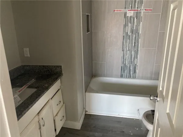 a bathroom with a bathtub and a shower