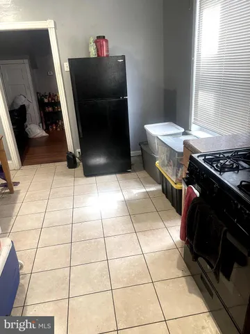 a kitchen with a black white checkered floor and a sink