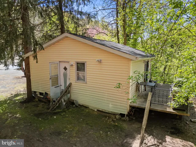 a view of a small house in a yard