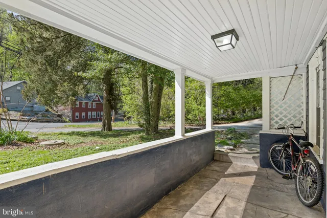 a view of a porch with furniture and garden