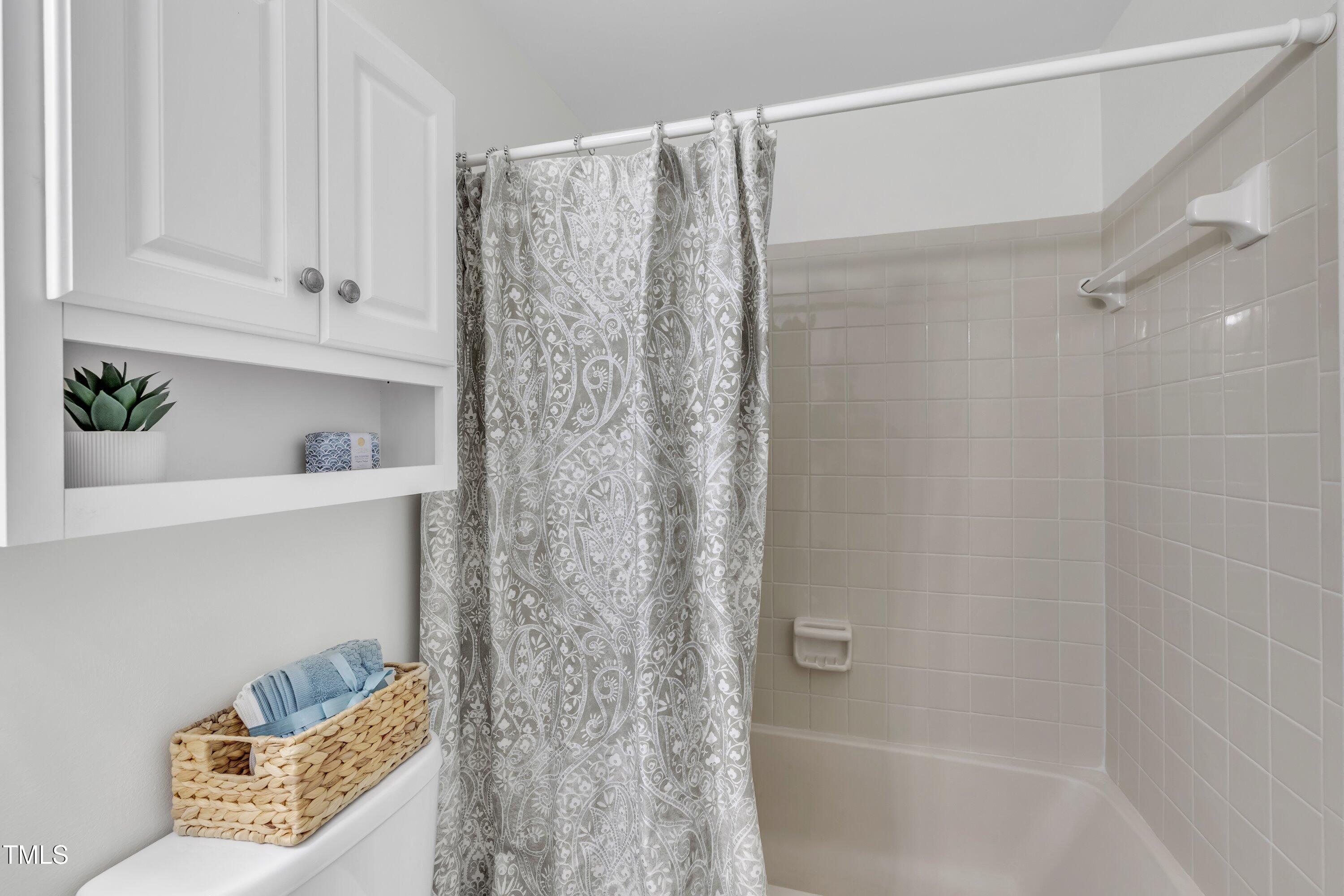 632 Middleton Avenue Cary, NC 27513 - Photo 25 of 34 a bathroom with a shower curtain and a bathtub