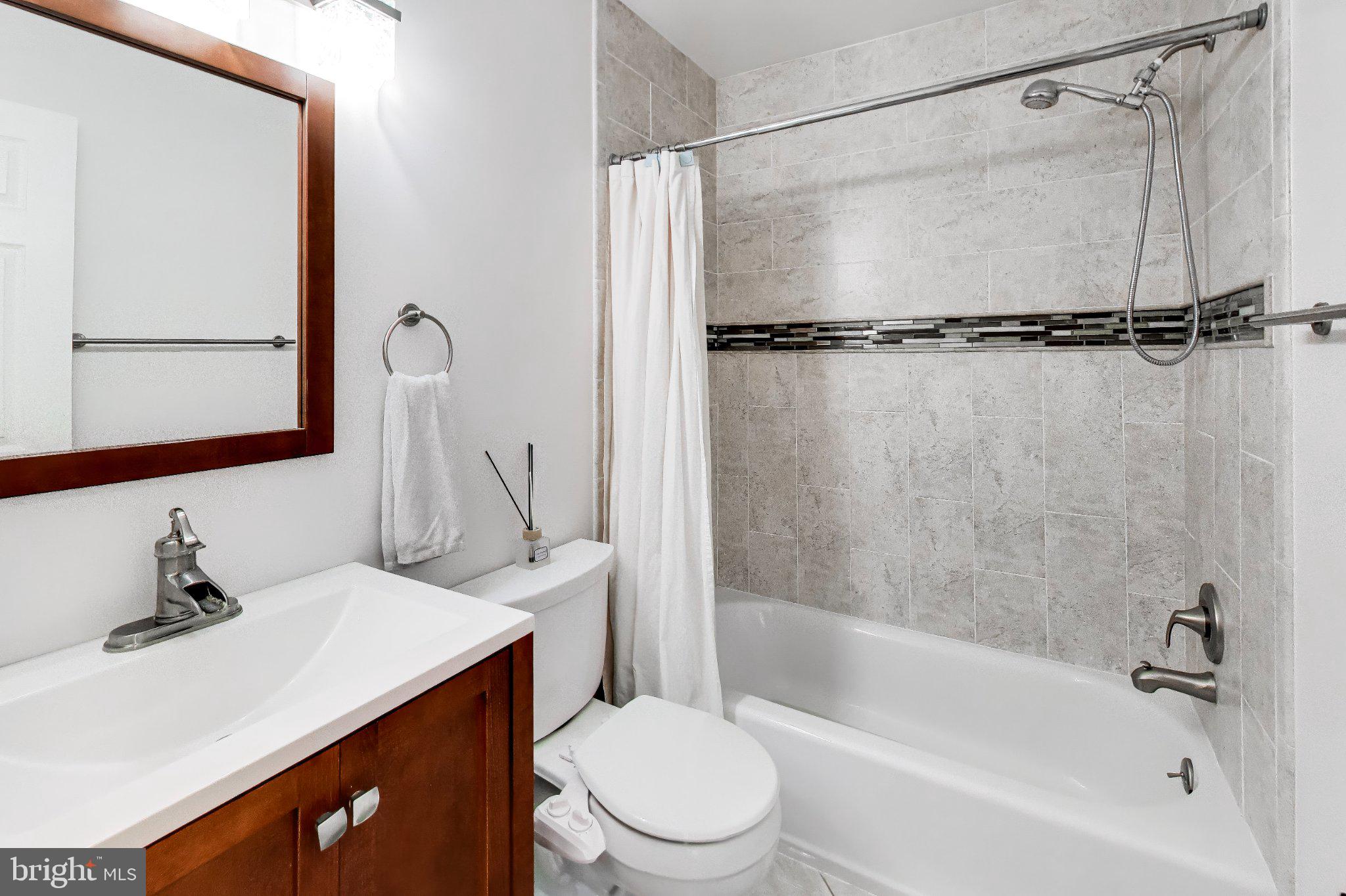 14216 Alderton Road Silver Spring, MD 20906 - Photo 34 of 63 a bathroom with a sink a toilet and a bathtub