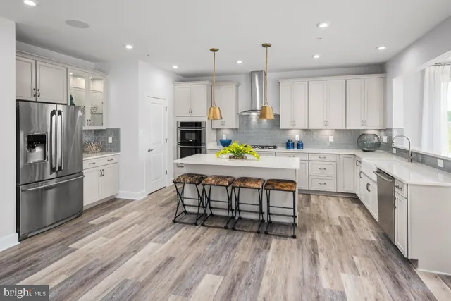 a kitchen with a sink appliances and cabinets