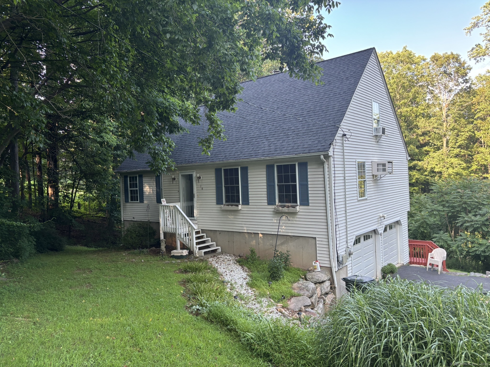 a view of a house with a yard and sitting area