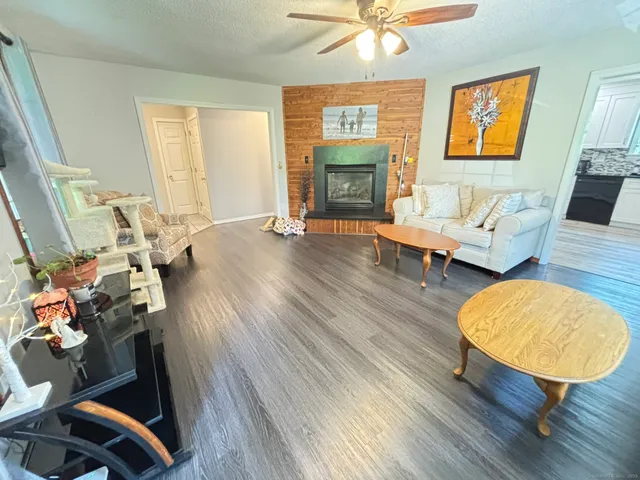 an outdoor living room with furniture and a fireplace