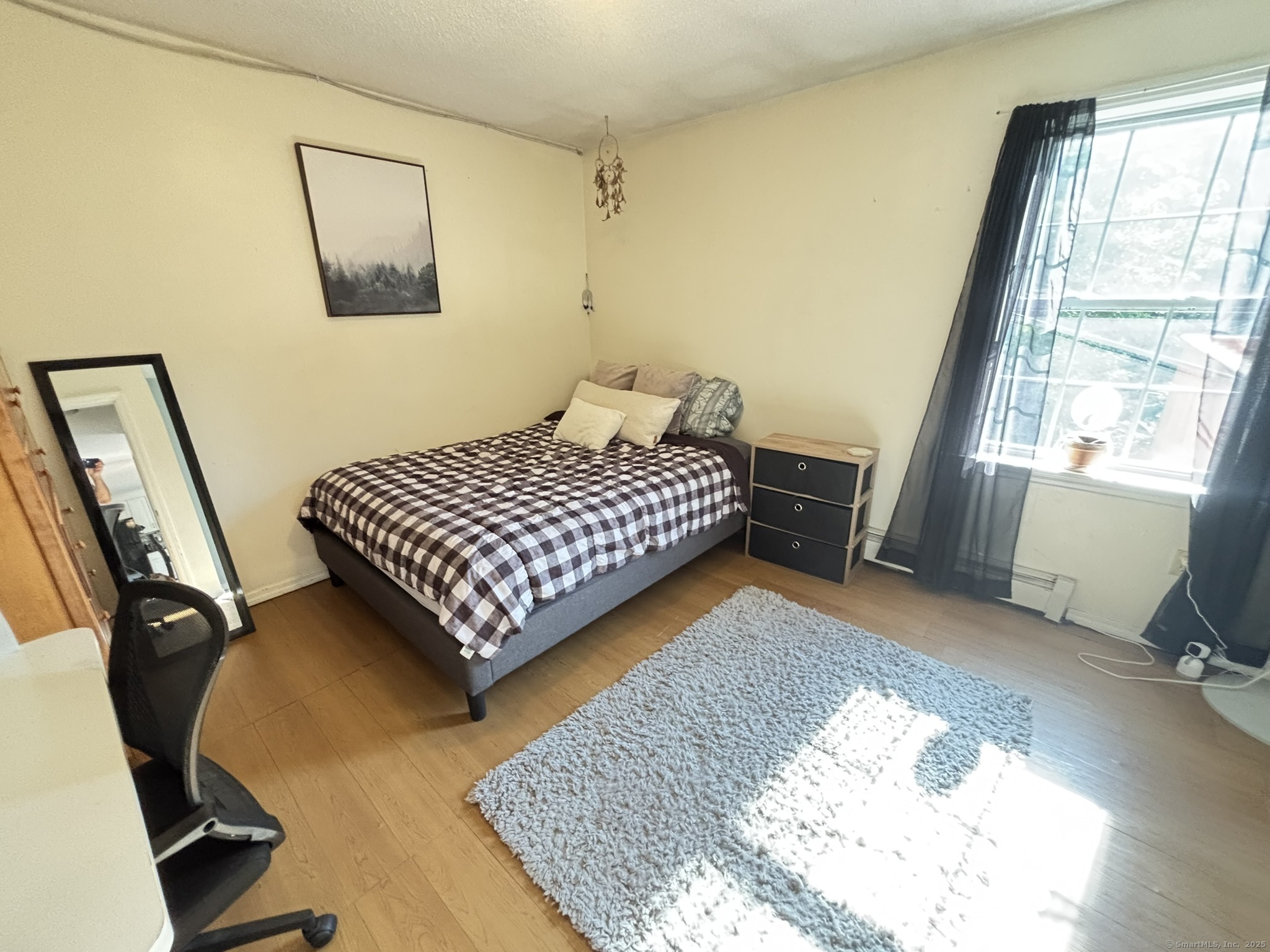 16 Plank Road Prospect, CT 06712 - Photo 17 of 40 a bedroom with a bed and wooden floor