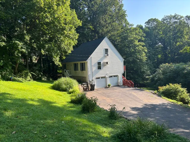 a view of backyard of house with green space