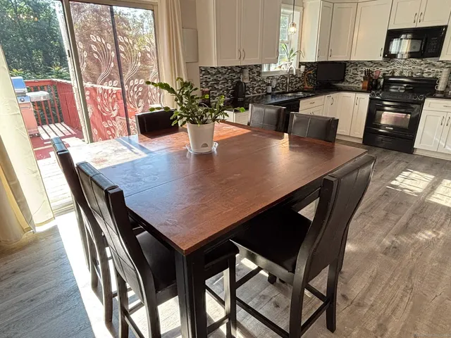 a kitchen with a dining table chairs and a counter top space