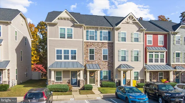 a front view of a residential apartment building with a yard