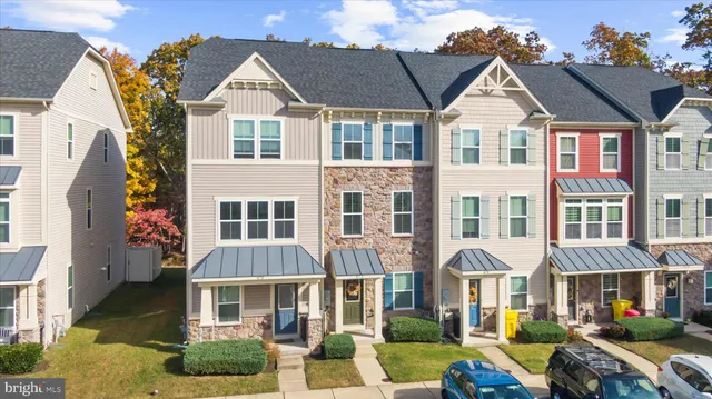 a front view of a residential apartment building with a yard