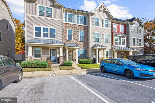 a car parked in front of a white building