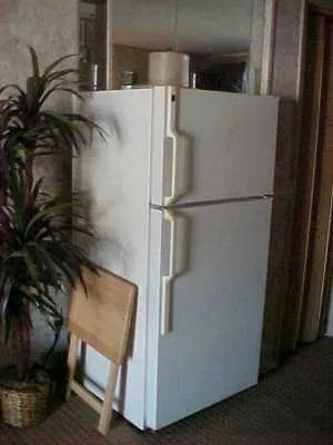 a white refrigerator freezer sitting in a kitchen