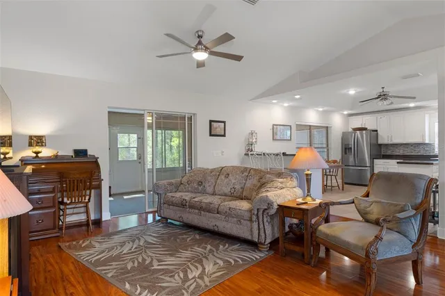 a bed room with a bed mirror and a chair