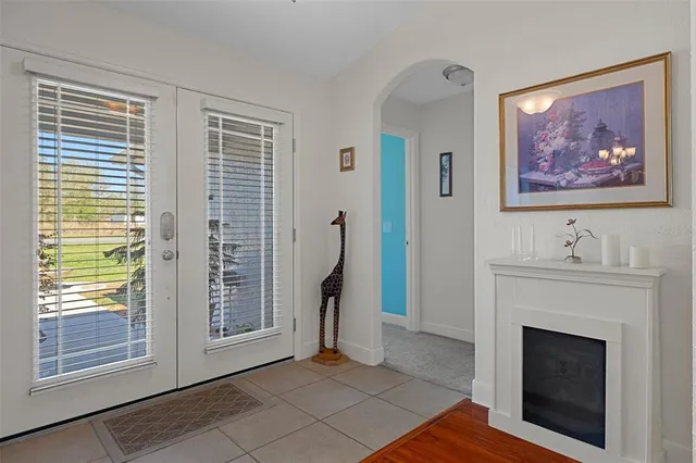 a kitchen with stainless steel appliances granite countertop a sink a stove a refrigerator cabinets and chairs