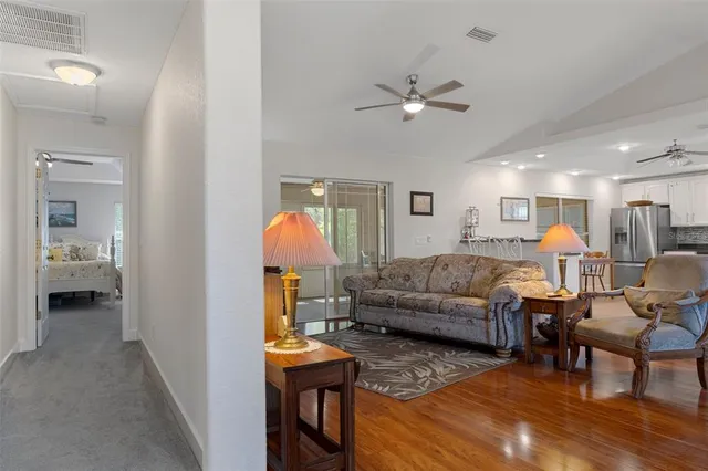 a living room with furniture and kitchen view