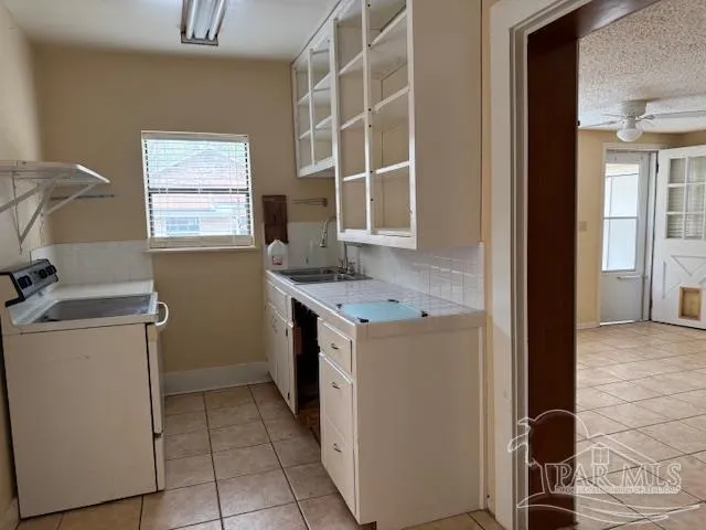 a utility room with cabinets washer and dryer