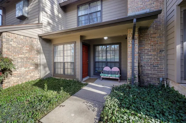 a view of a brick house with a large windows