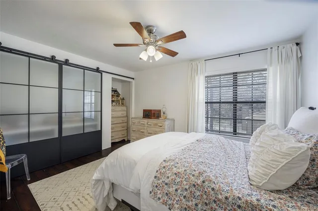 a bedroom with a large bed and a window