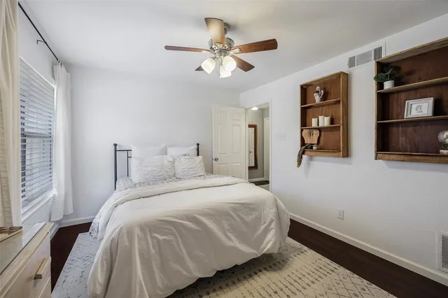a bedroom with a large bed and a chandelier