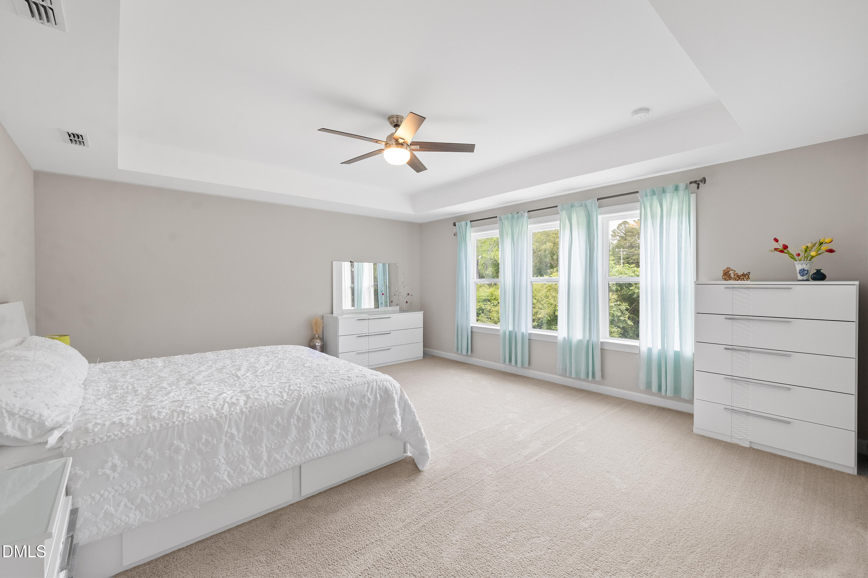 8059 Gilano Drive Raleigh, NC 27603 - Photo 26 of 43 a bedroom with a bed a dresser and a chandelier