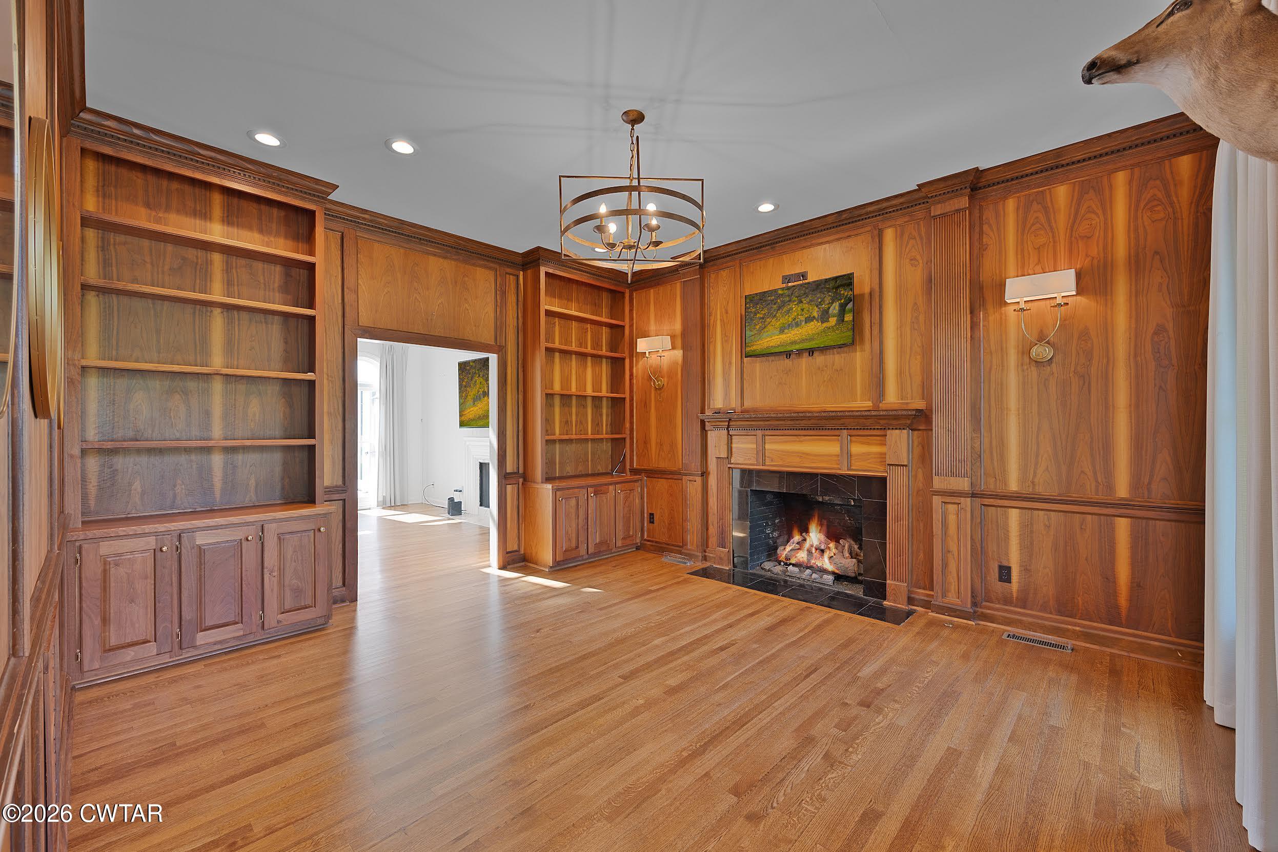 58 Huntington Place Jackson, TN 38305 - Photo 24 of 38 a view of an empty room with wooden floor fireplace and a window