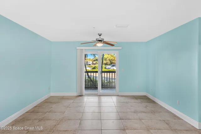 an empty room with windows and chandelier