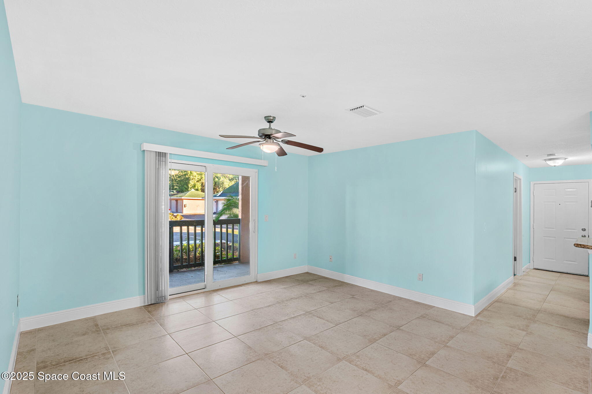 7667 North Wickham Road, Unit 103 Melbourne, FL 32940 - Photo 12 of 39 an empty room with windows and chandelier