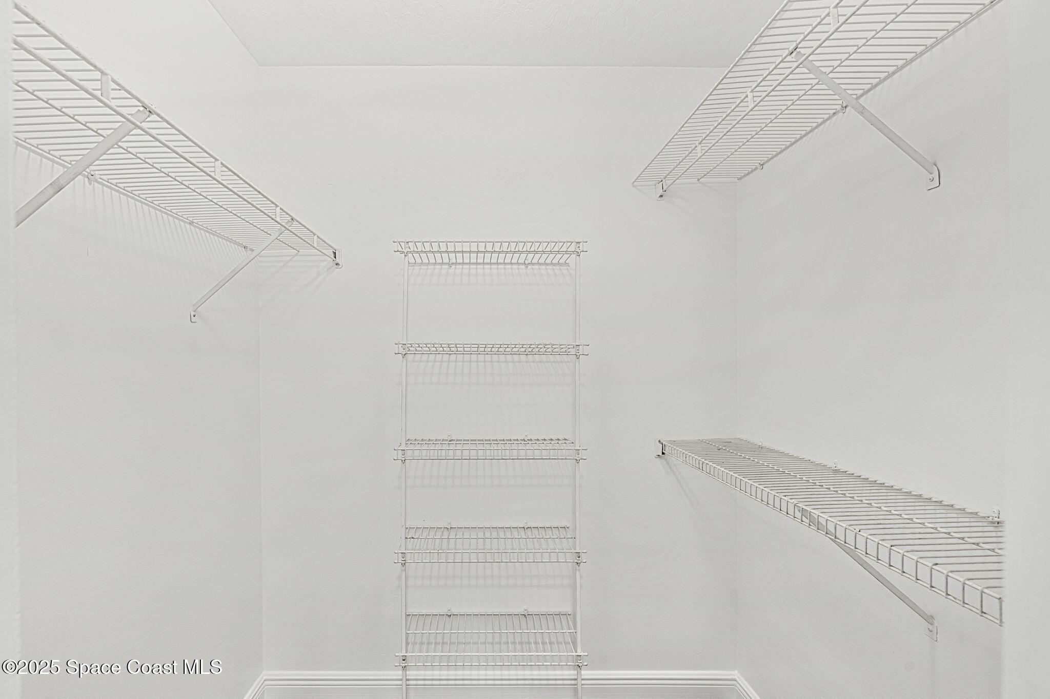 7667 North Wickham Road, Unit 103 Melbourne, FL 32940 - Photo 17 of 39 a view of walk in closet with empty racks
