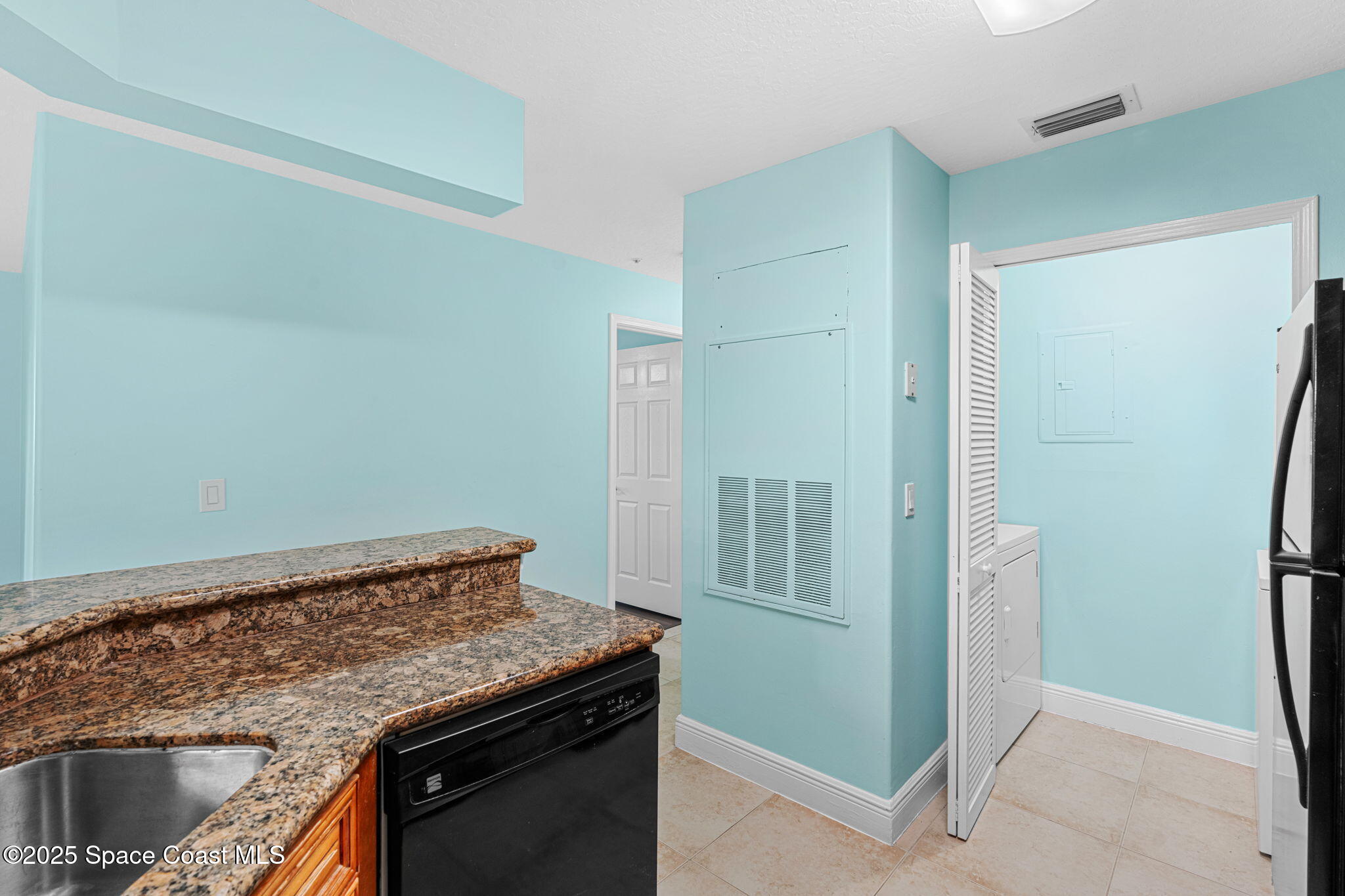 7667 North Wickham Road, Unit 103 Melbourne, FL 32940 - Photo 22 of 39 a utility room with washer and dryer