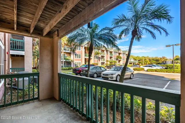 a living room with a bed and a chair