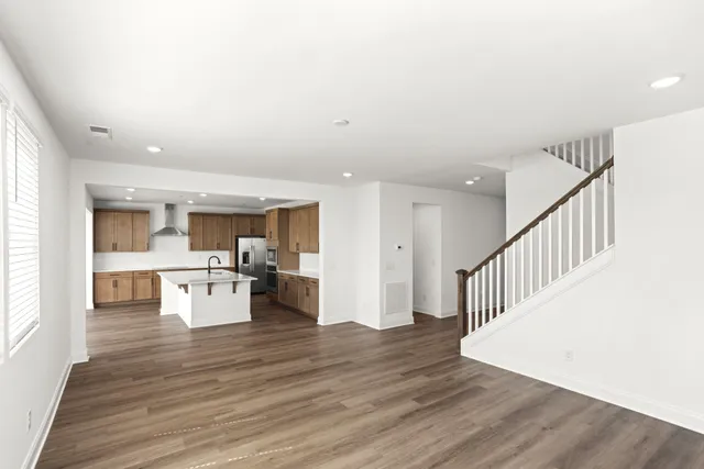 a kitchen with kitchen island sink stove and refrigerator