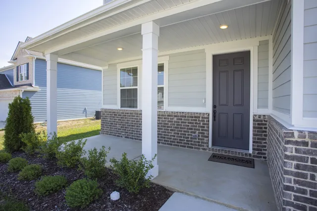 a view of a house with backyard and porch
