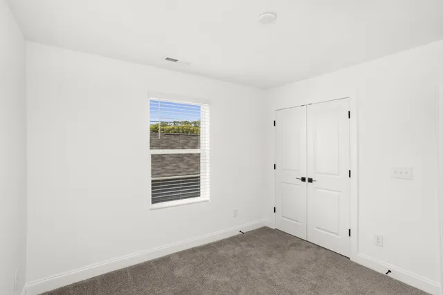 a spacious bathroom with a granite countertop sink mirror and a shower