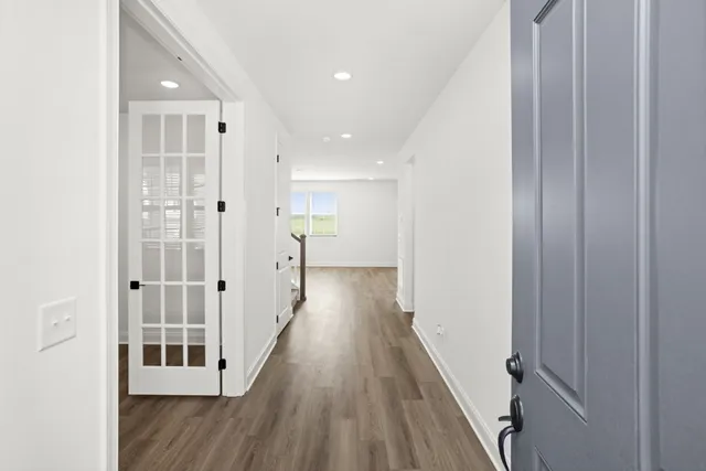 a view of a hallway with wooden floor
