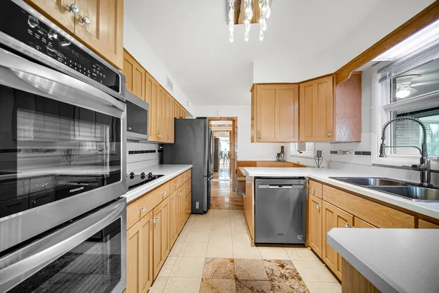 a kitchen with stainless steel appliances granite countertop a sink and cabinets