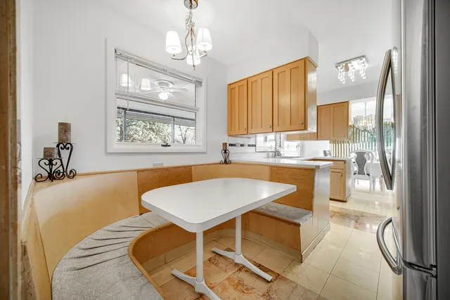 a kitchen with a table chairs sink and cabinets