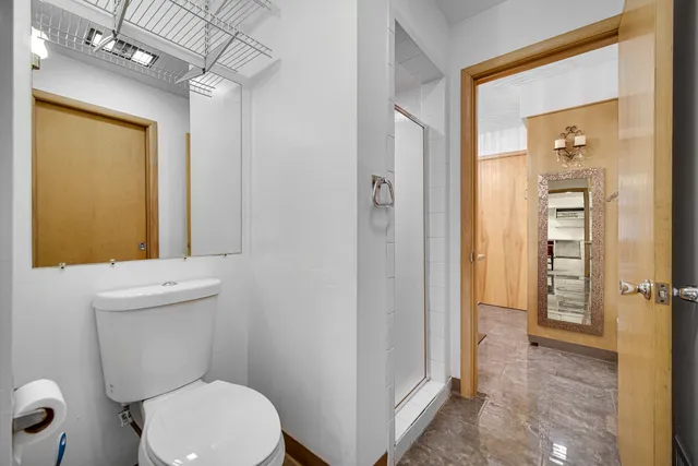 a bathroom with a toilet and a shower
