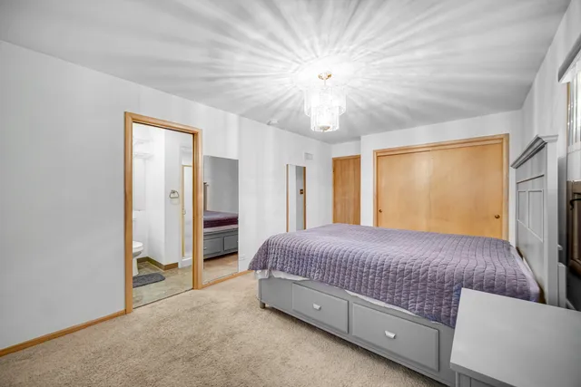 a living room with a bed and a chandelier
