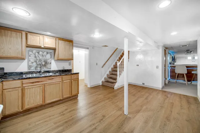 a view of kitchen with cabinets stainless steel appliances and wooden floor