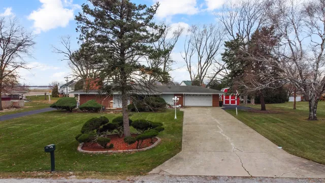 an aerial view of a house with a yard basket ball court and outdoor seating