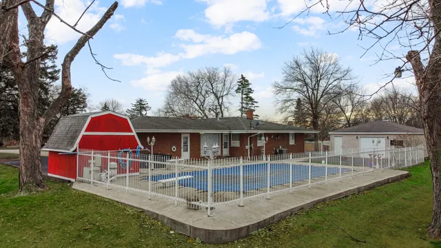 an aerial view of a house with swimming pool and garden