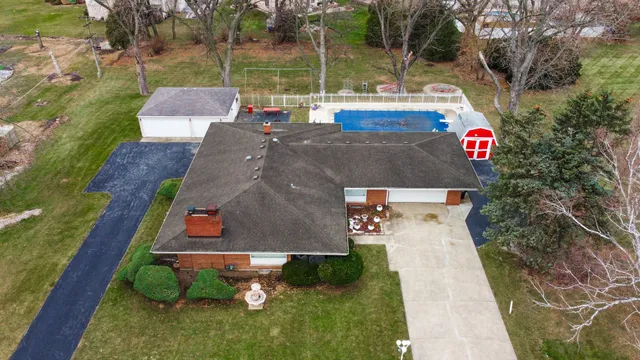 an aerial view of a city with lots of residential buildings ocean and mountain view in back
