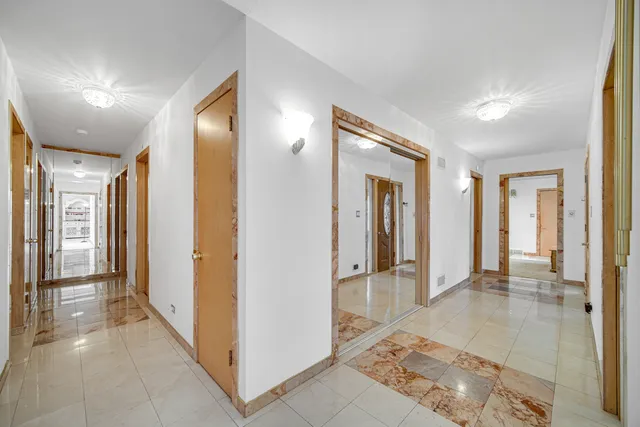 a view of a hallway with wooden shelves