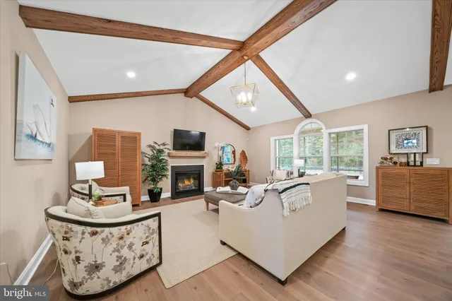 a living room with fireplace furniture and a flat screen tv
